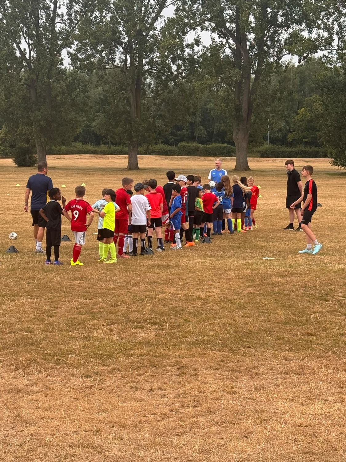 Excel Coaching coach leading a kids' football session in Telford